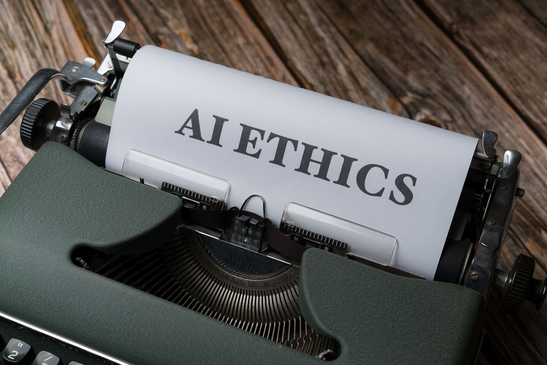 Ilustrasi: Retro typewriter with 'AI Ethics' on paper, conveying technology themes.